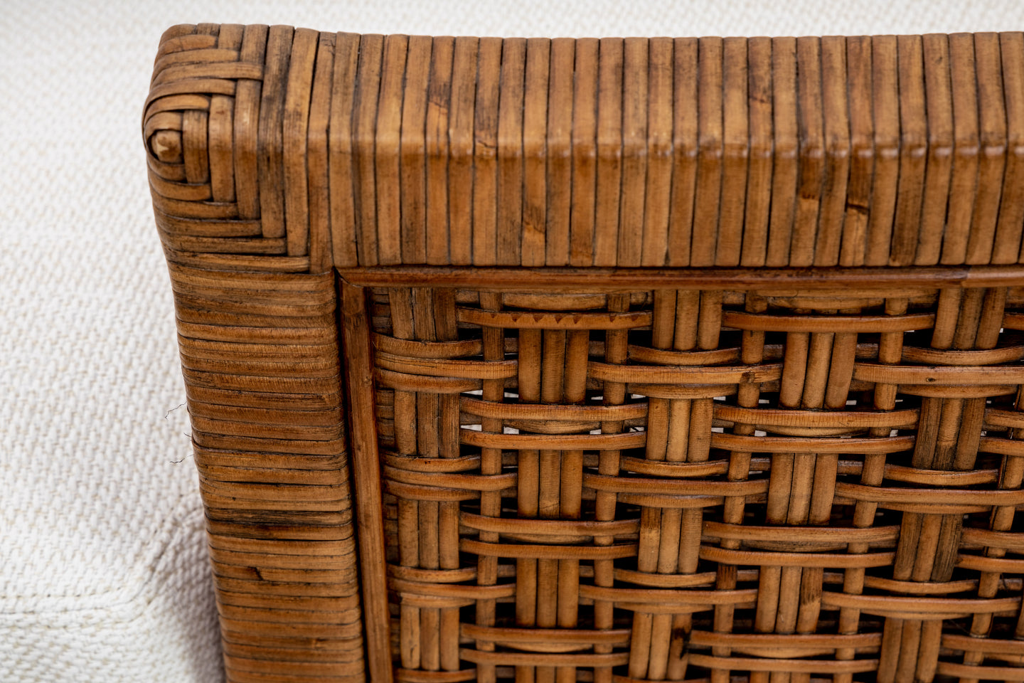 Close-up of McGuire Furniture's St. Germaine Chair showcases the exquisitely crafted woven wicker backrest, elegantly complemented by a light textured cane wrap surface.