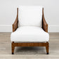 The McGuire Furniture St. Germaine Chair, featuring cushions in Perennials Sea Salt Cognac Fabric, is elegantly placed on a light wood floor against a plain white wall.