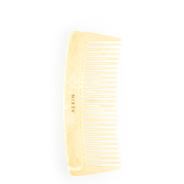 An AERIN Travel Ivory Comb on a white background with a touch of Italy's luxe.