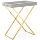 The Aerin Butler Tray Stand features a gray rectangular top, gold X-shaped folding legs, and short side handles—perfect for tableside serving or entertaining at home.