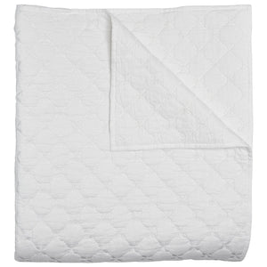 The Layla White Bedding Collection by John Robshaw features a hand quilted cotton voile quilt with a subtle geometric stitched pattern, folded at one corner to display both the front and back.