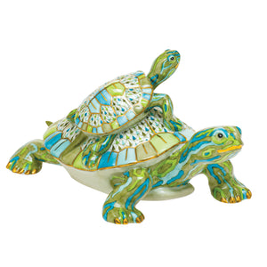 The Herend Reserve Collection Pair of Turtles in green multicolor features a small, hand-painted ceramic turtle atop a larger one, both showcasing exquisite artistic craftsmanship and vibrant designs.
