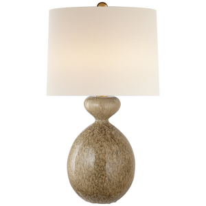 A Gannet table lamp by Visual Comfort with a rounded, textured base in a light beige color and a plain, large white lampshade. Its height adds an elegant dimension to its design.