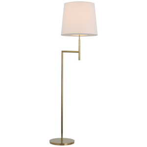Visual Comfort's Clarion Bridge Arm Floor Lamp in Soft Brass with a sleek gold stand, a small rectangular side table, and a white linen shade, on a transparent background.