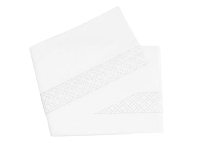 The HIVE Exclusive Rovella Bedding Collection by Matouk features white folded sheets with a subtle geometric lattice edge, crafted from luxurious Egyptian cotton percale and displayed on a plain white background.
