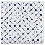 The Layla Indigo Coverlet by John Robshaw is a folded white cotton voile coverlet, hand quilted with a navy geometric pattern inspired by Mughal gardens, featuring circular four-petal motifs.