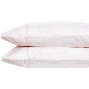 Stacked one atop the other, two white pillows from the John Robshaw Poseti Lotus Sheet Set feature subtle patterned texture with pink decorative stitching, crafted from organic percale cotton.
