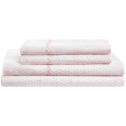 A neatly folded stack of the John Robshaw Poseti Lotus Sheet Set in light pink and white organic percale cotton, featuring a subtle decorative trim—an ideal layering essential for your bed.