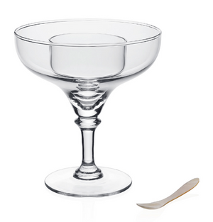 The Sasha Seafood/Caviar Server by William Yeoward Crystal, a handmade glass dish with a wide rim and short stem, is set beside a small, flat spoon on a white background.