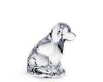 The Simon Pearce Glass Puppy is a clear glass figurine of a sitting dog, viewed from the side on a white background—an elegant nod to cherished canine companionship.