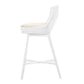 Side view of the McGuire Furniture Maketto Barstool in White, showcasing a tall white wicker chair with a beige cushioned seat, long legs, and a crossbar. This elegant handmade piece enhances any space.