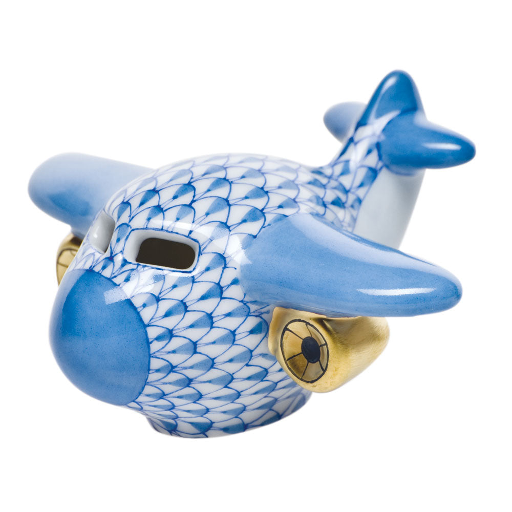 The Herend Airplane, Blue is a porcelain figurine with hand-painted scale patterns in blue and white and gold-colored engines, displayed on a plain white background.