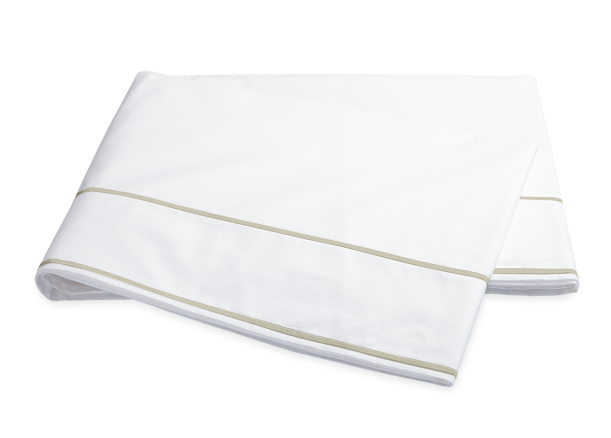 A folded white bedsheet from the Ansonia Bedding Collection by Matouk, made of luxurious Egyptian cotton percale with two light beige stripes near the edges, shown on a plain white background in the Almond color.