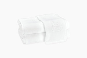 Two Matouk Auberge Monogram Bath Towels stacked on top of each other, perfect for monogramming at auberges.