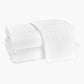 Two neatly folded Matouk Auberge Monogram Bath Towels, one draped over the other, featuring a prominent "G" embroidery—an elegant upgrade for any guest bath.