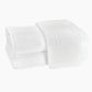 Two crisp white Matouk Auberge Monogram Bath Towels, one atop the other with a large embroidered "L," add a refined touch of hotel style to your guest bath.