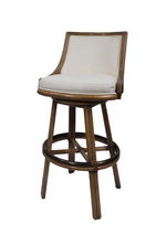 The McGuire Furniture Rattan Swivel Bar Stool features a cushioned backrest and seat, complete with a swivel base and footrest ring, standing at 42 inches tall.