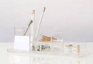 The Russell & Hazel Acrylic Pencil Block stylishly organizes essential writing supplies such as pencils, rubber bands, binder clips, paper clips, washi tape, and note cards on a pristine white surface.