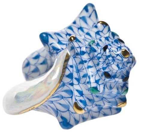 The Herend Small Conch Shell is a porcelain figurine hand painted in blue, white, and gold, featuring an iridescent inner surface perfect for display and artistic appreciation.