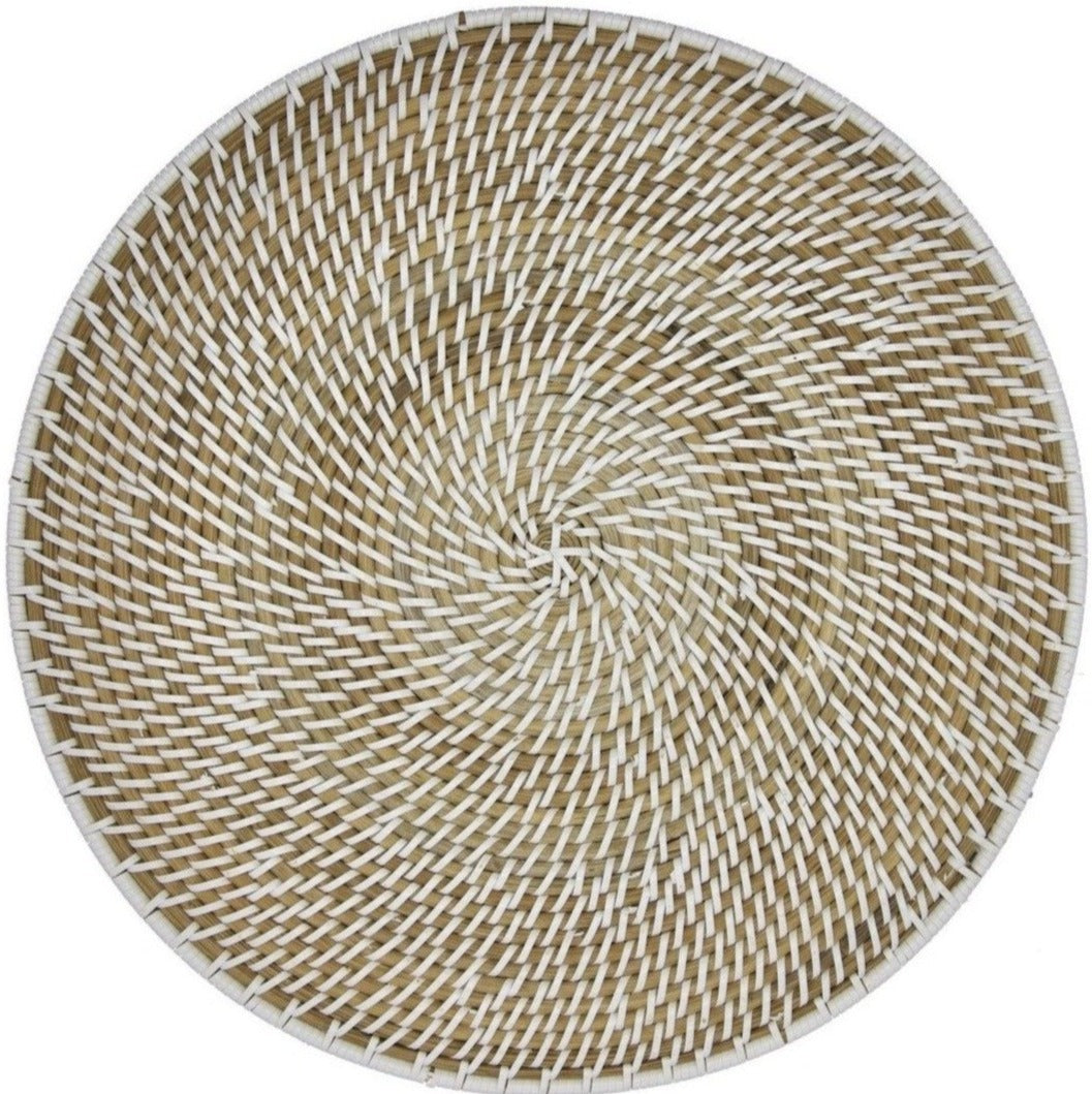 The Calypso Rattan Placemat Set by Deborah Rhodes features hand-woven round trays with a spiral design in natural and white fibers, ideal as versatile indoor-outdoor placemats for any setting.