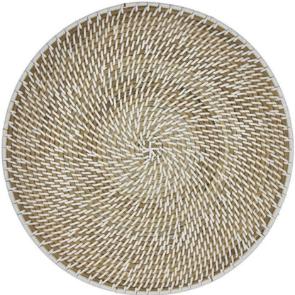 The Calypso Rattan Placemat Set by Deborah Rhodes features hand-woven round trays with a spiral design in natural and white fibers, ideal as versatile indoor-outdoor placemats for any setting.