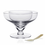 The William Yeoward Crystal Caspia Seafood and Caviar Server with Spoon features clear glass with a wide rim and short pedestal, perfect for shrimp cocktail or caviar, shown beside a small white spoon.