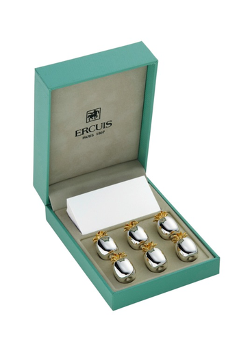 A green Ercuis box containing six silver Pineapple Placecard Holders with gold accents and a white card.