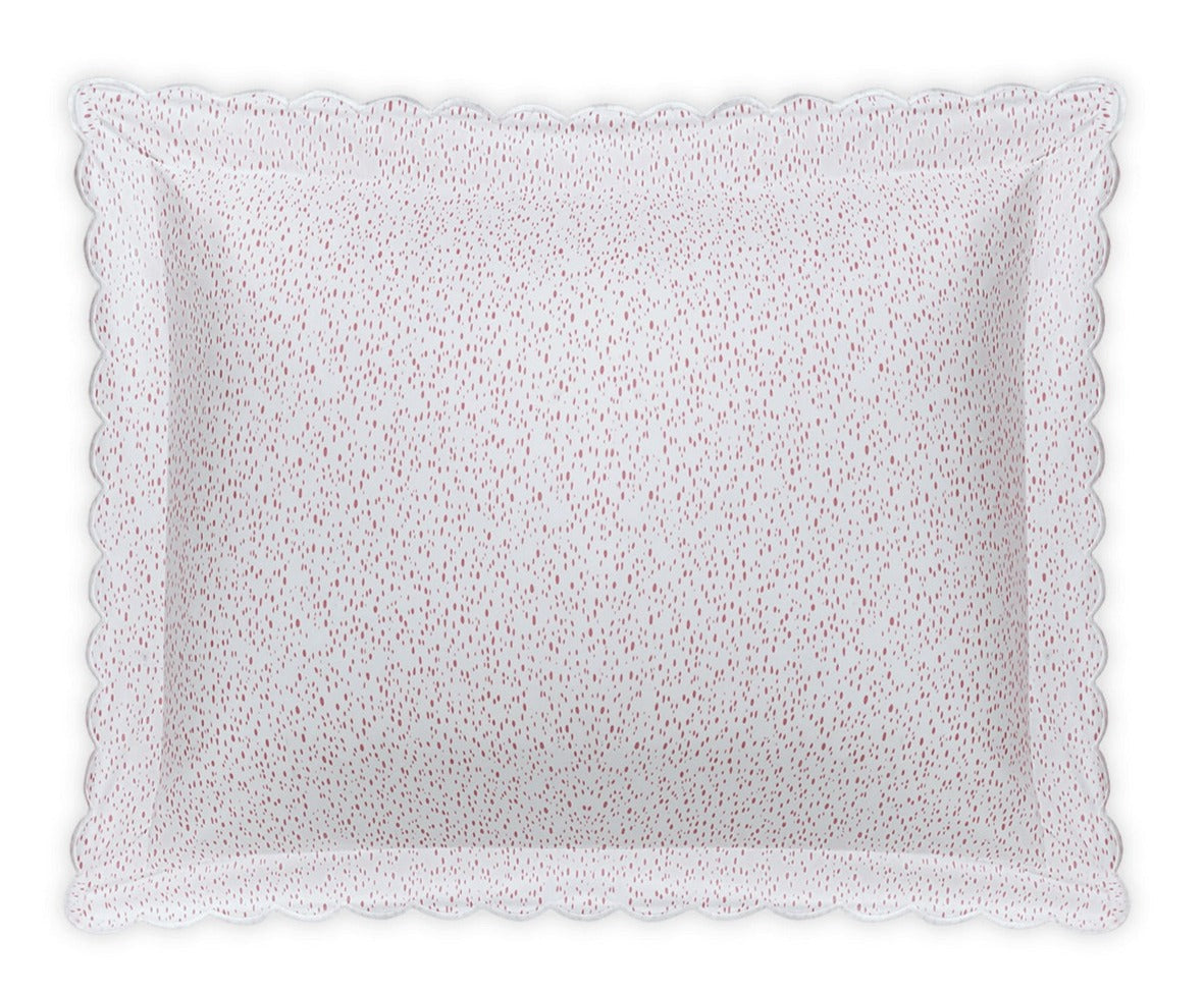 The Matouk Celine Bedding Collection in Pink features a rectangular white pillow with scalloped edges and small red dots, made from OEKO-TEX certified Egyptian cotton percale for premium softness and quality.