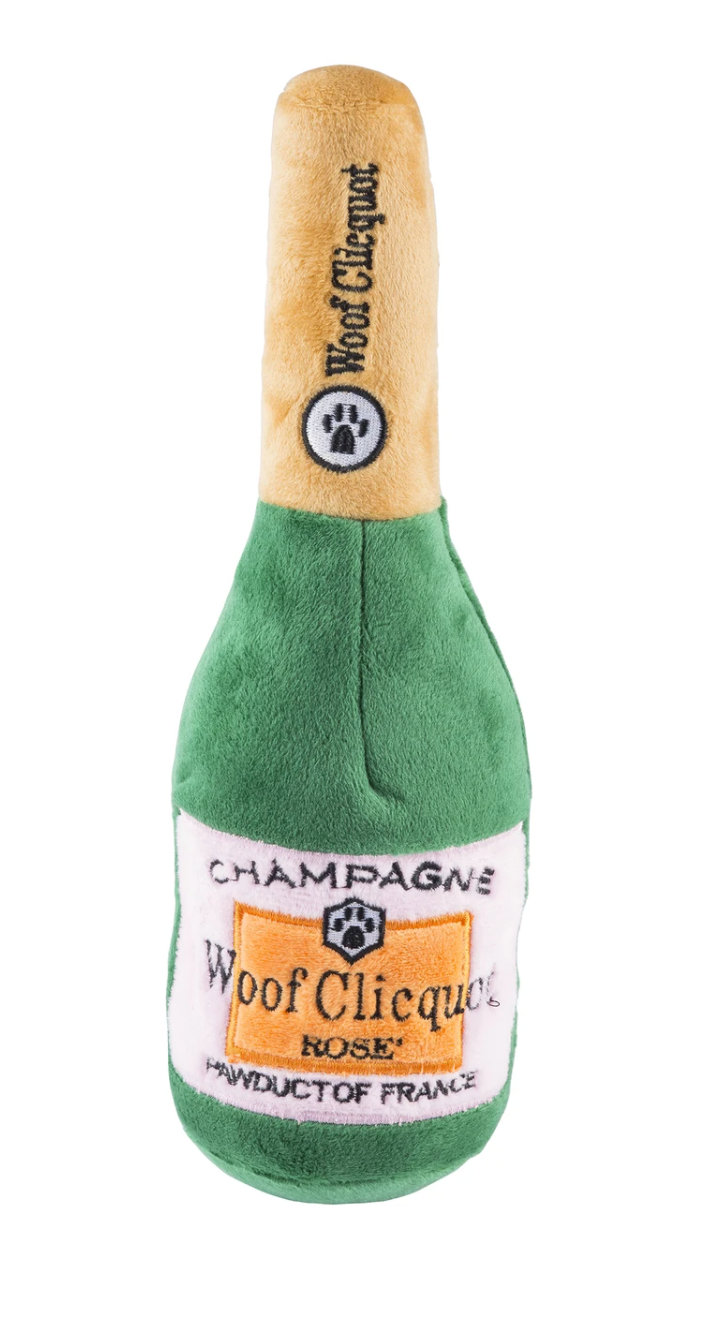 The Haute Diggity Dog Woof Clicquot Rose Champagne Bottle Dog Toy, Small, is a plush bottle toy from the Muttini Bar Collection, featuring a playful "Woof Clicquot Rosé" label and “PAWDUCT OF FRANCE” for pups with refined taste.