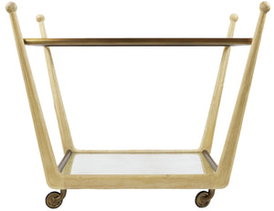 The Rosa Trolley Cart in Bleached Oak, crafted by Julian Chichester, features a glass top and bottom shelf, angled legs, and four brass castors for easy mobility.