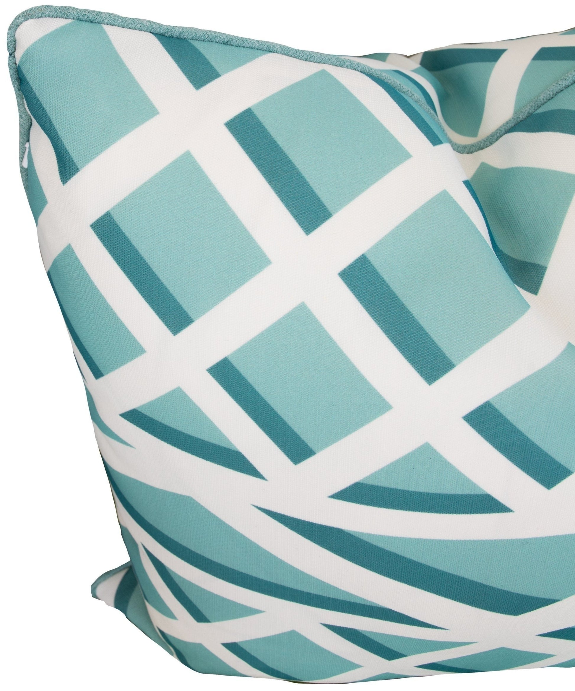 A close-up of the Treillage Bleu Outdoor Pillow by Associated Design, handmade in the USA, showcasing a white and teal geometric pattern with intersecting lines and shapes.