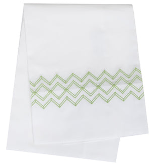 The HIVE Exclusive Arezzo Bedding collection by Matouk, made from luxurious Egyptian cotton percale, features a white base with a striking Spring Green zigzag horizontally across the center and elegant hemstitch detailing.