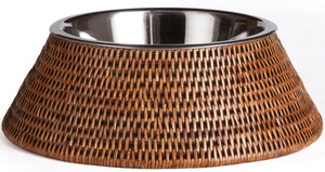 The Napa Home & Garden Burma Rattan Pet Bowl features a stainless steel bowl set within a wide, woven rattan holder, shown on a white background.