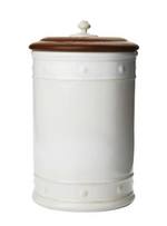 The Juliska Berry & Thread Whitewash 13" Canister features a round white ceramic stoneware body and an ash wood lid with a small knob handle on top.