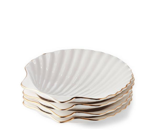 A stack of white AERIN Shell Appetizer Plates with gold trim.