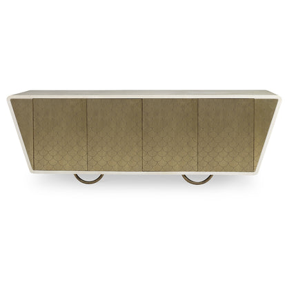 The Julian Chichester Danish Fishscale Cabinet is a modern sideboard with a beige textured front in a fishscale pattern, featuring a sloped design and circular metal legs wrapped in brass.