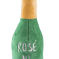 The Haute Diggity Dog Woof Clicquot Rose Champagne Bottle Dog Toy, Small, is a plush toy from the Muttini Bar Collection featuring green and gold colors and "ROSÉ ALL DAY" embroidered on the front.