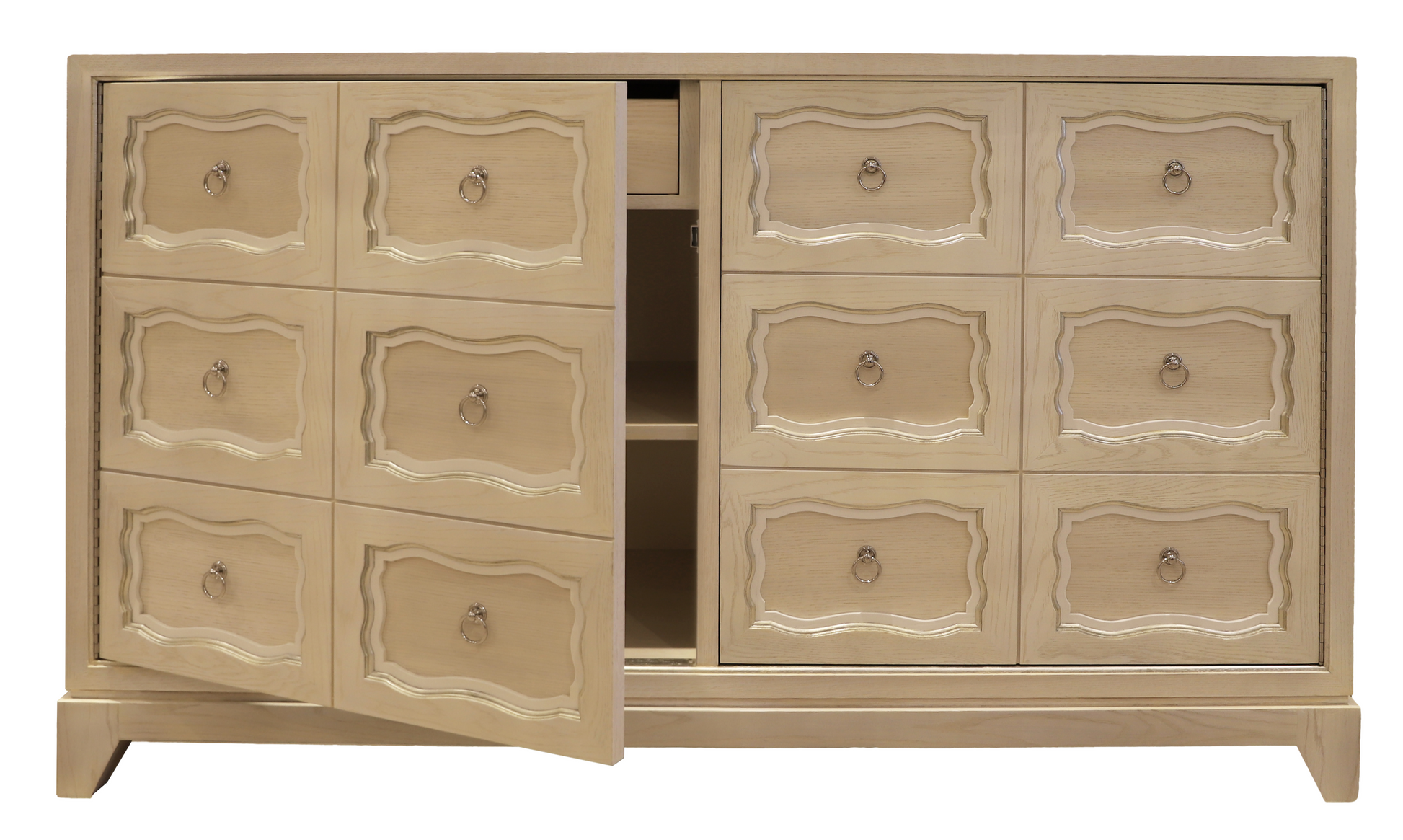 The Kindel Dorothy Door Chest is a beige wooden dresser with ornate drawer fronts and brass ring pull hardware in the Dorothy Draper style, featuring an open door revealing cerused white shelves and an inner drawer.