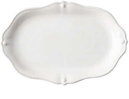 The Juliska Berry & Thread Whitewash 16" Platter features an oval ceramic shape with a scalloped edge and subtle detailing, perfect for enhancing your dinnerware collection.