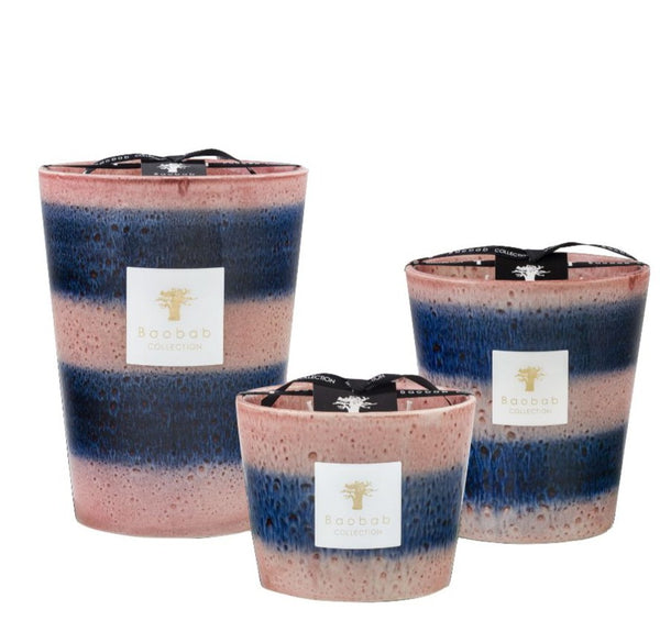 Three Baobab Collection Elementos Téthys candles in varying sizes, depicting a gradient color transition from blue to pink, each with a Baobab label on the front.