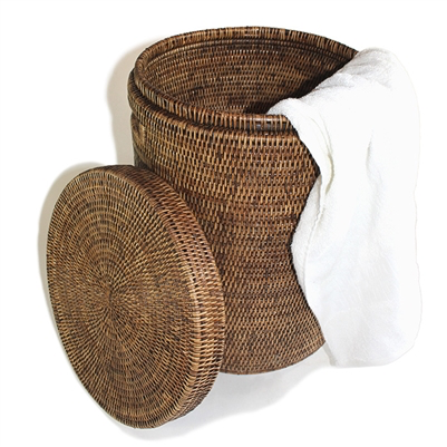A Matahari Round Laundry Hamper, Small, Antique Brown with dimensions provided, its lid off and a white towel hanging over the side on a white background.