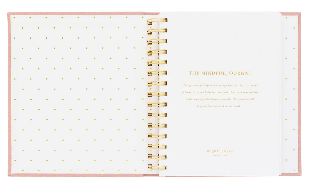 The Mindful Journal by Sugar Paper features an open spiral-bound design, gold polka dot endpapers, and a gold-lettered title page—ideal for daily reflection.