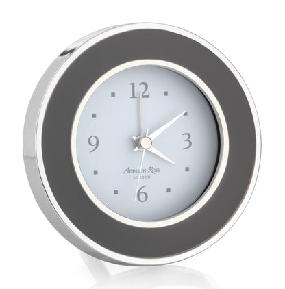An Addison Ross Round Alarm Clock in silver and black, inspired by classic alarm clocks, shows the time as 1:10:35.