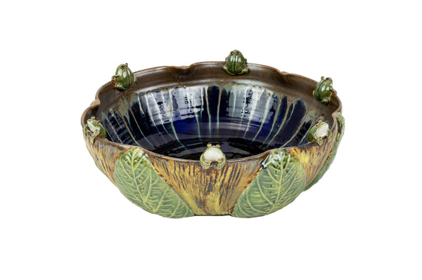 A Van Cleve Collection ceramic Frog Bowl, Medium with leaves on it, perfect for adding a touch of nature to your outdoor space.
