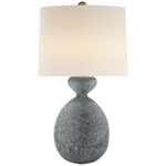 A textured, Gannet Table Lamp in Blue Lagoon with an oval base and a large white lampshade, featuring an E26 dimmer, set against a neutral background. Brand: Visual Comfort.