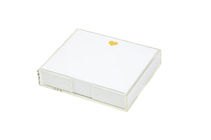 The Black Ink Heart Large Notepad features a stack of smooth white cardstock in a clear Lucite holder, with the first sheet adorned by a luxe gold foil heart.