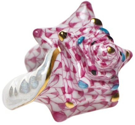The Herend Small Conch Shell ring features a pink and white seashell design with blue spots and gold accents, highlighting hand-painted artistry on a smooth band for an elegant, artistic look.