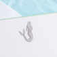 An embossed silver mermaid design on white paper with a seafoam green border and a hint of azure tissue envelope in the background—perfect for the Printery Mermaid Card Set.