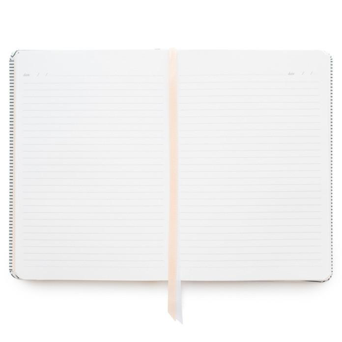The Sugar Paper Tailored Chambray Journal features an open hardcover wrapped in chambray bookcloth, lying flat with a ribbon bookmark and two blank lined pages ready to be filled.