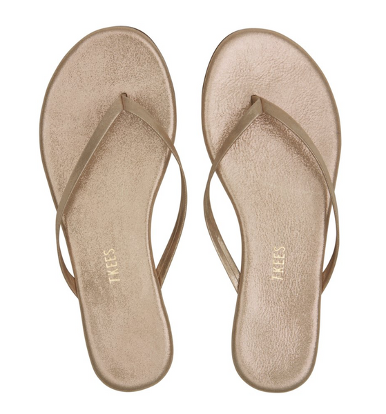 A pair of Tkees Women’s Glitter Sandals in beige that sparkle with glitz.